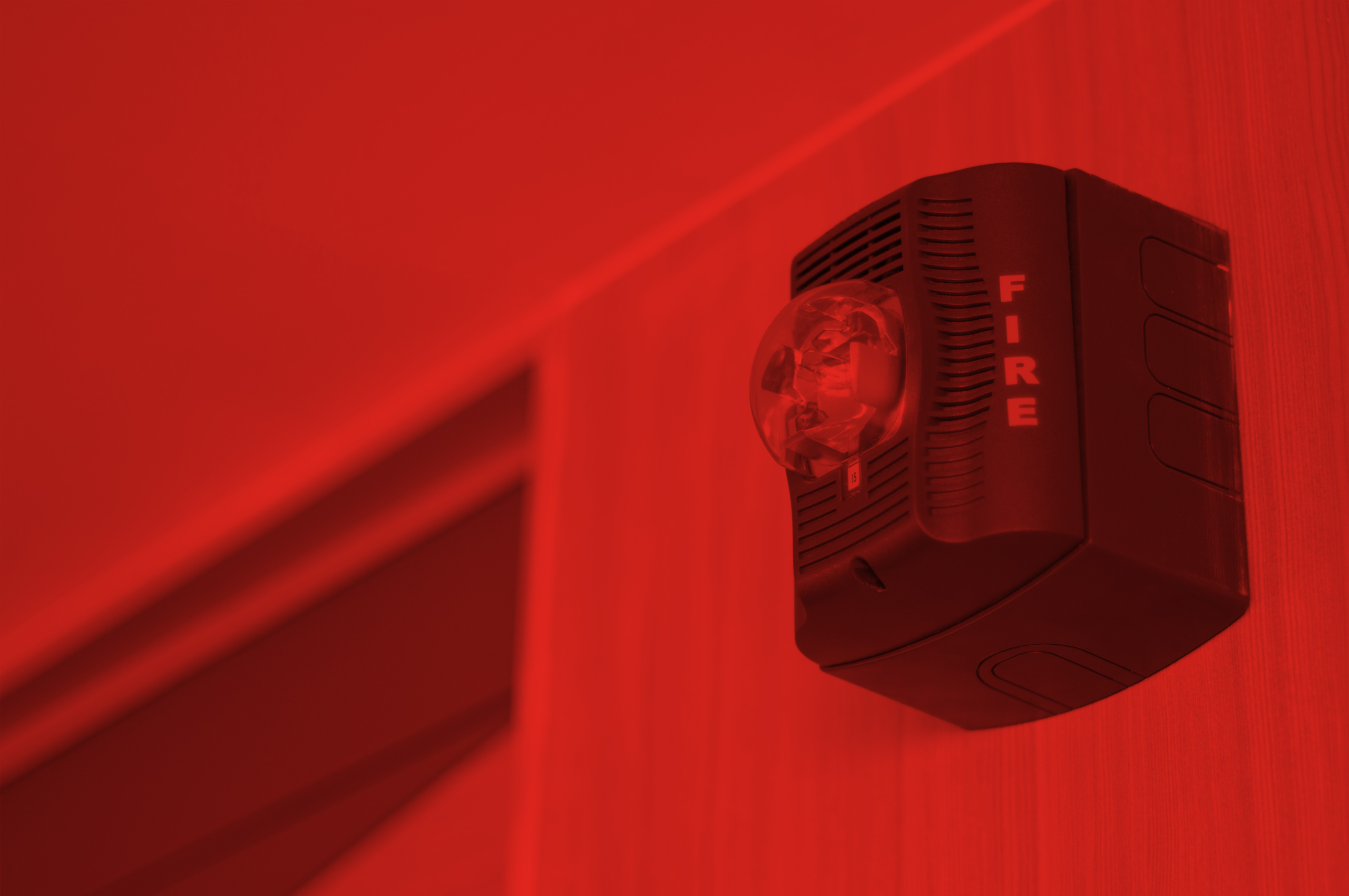 Fire alarm horn mounted to an interior wall