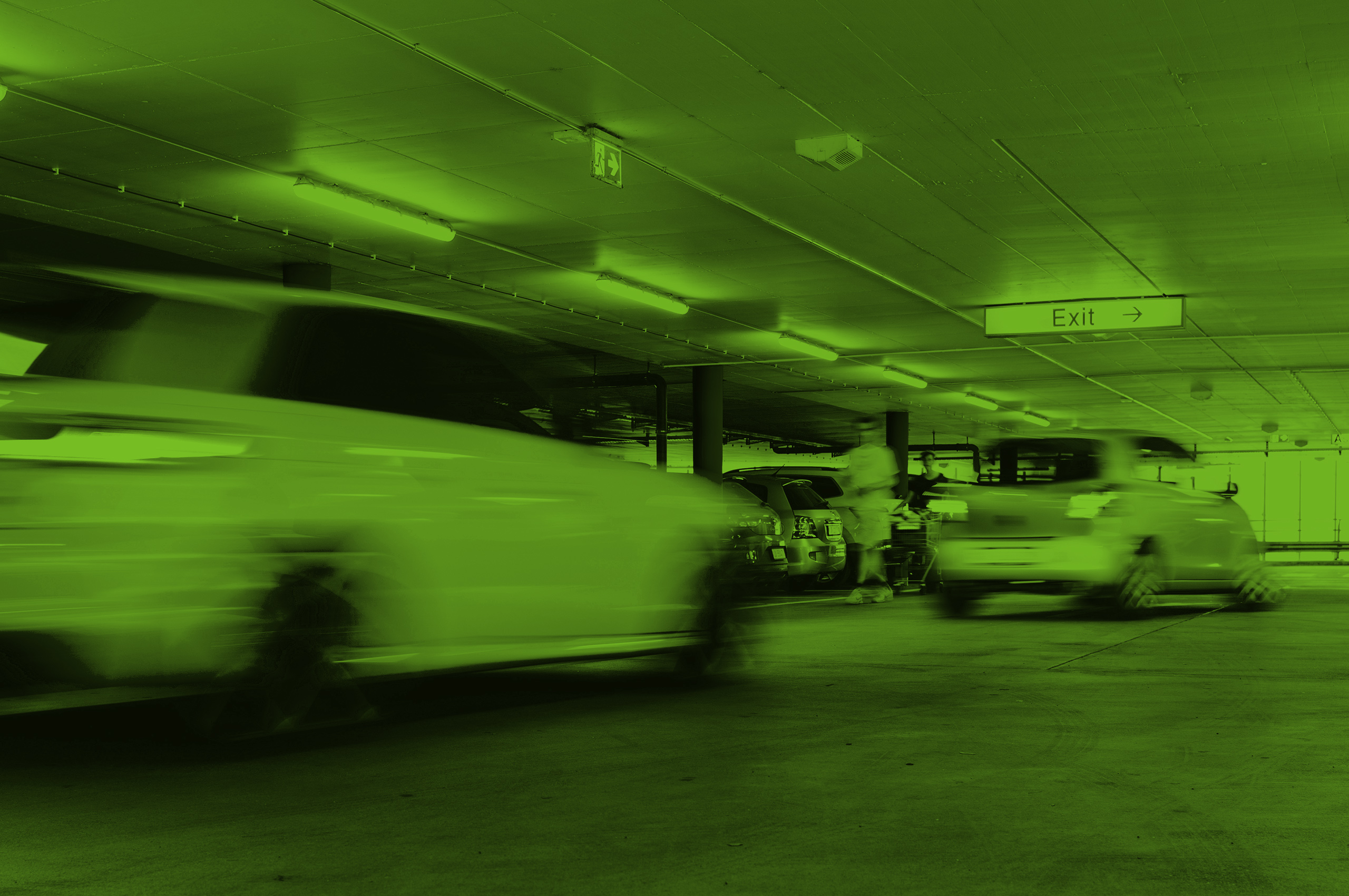 Cars driving through an enclosed parking garage