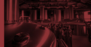 Rows of industrial brewing tanks stand ready, reflecting the advanced equipment used in crafting high-quality beer.