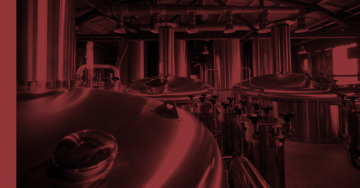 Rows of industrial brewing tanks stand ready, reflecting the advanced equipment used in crafting high-quality beer.
