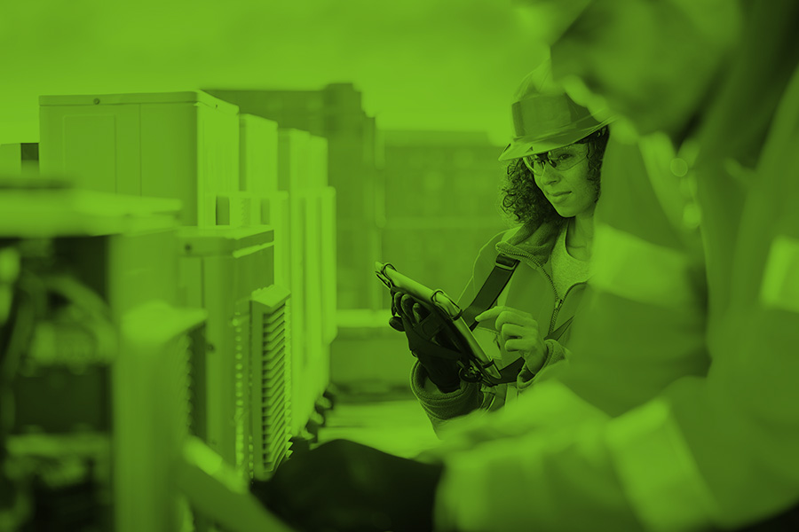Monochrome photograph of two HVAC technicians making commercial inspections
