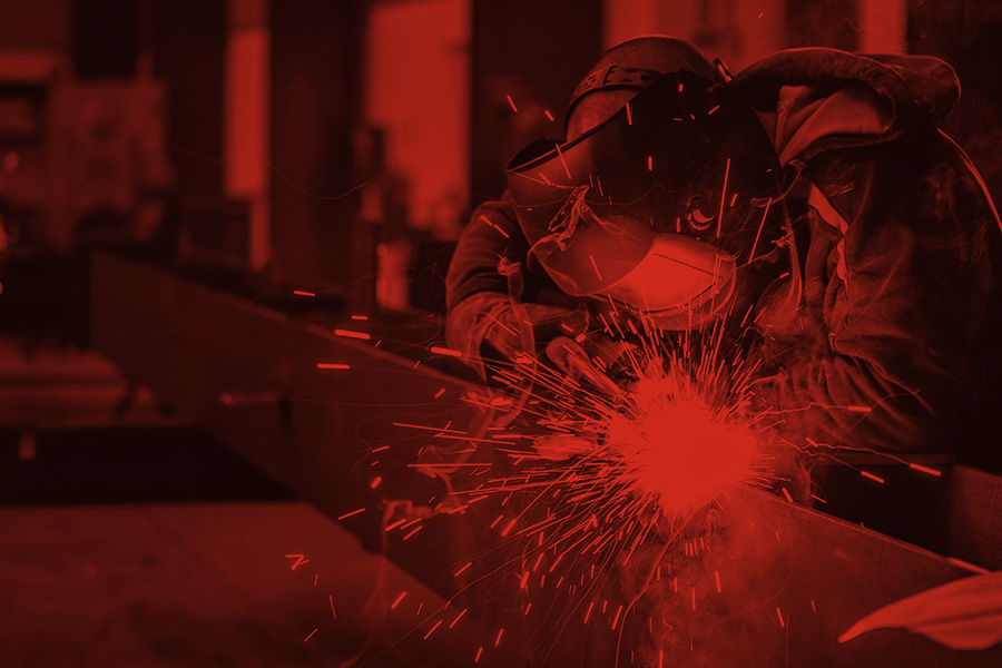 Monochrome photograph of a worker using a welder