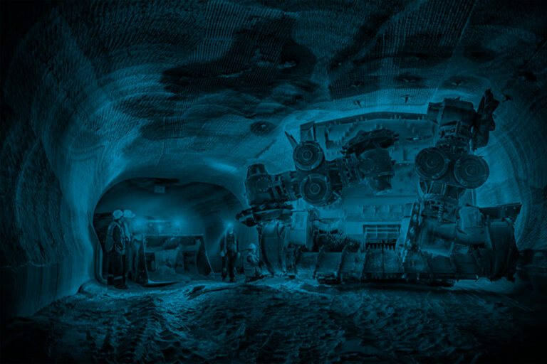 Mine personnel inspect progress in potash mine.