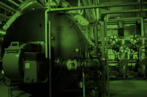 Boiler and other mechanical systems in the machinery room of a commercial building.
