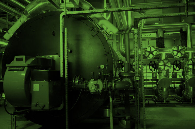 Boiler and other mechanical systems in the machinery room of a commercial building.