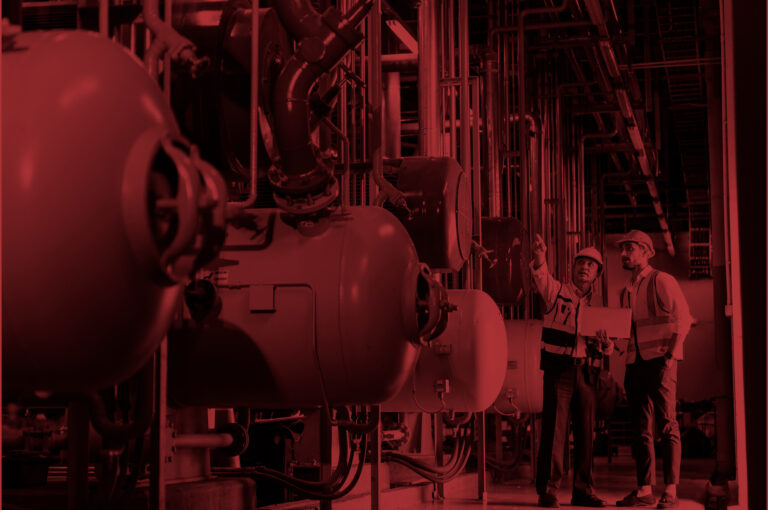 Two professional electrical engineer in safety uniform working together at factory site control room. Industrial technician worker maintenance power system pipeline at manufacturing industry plant room.