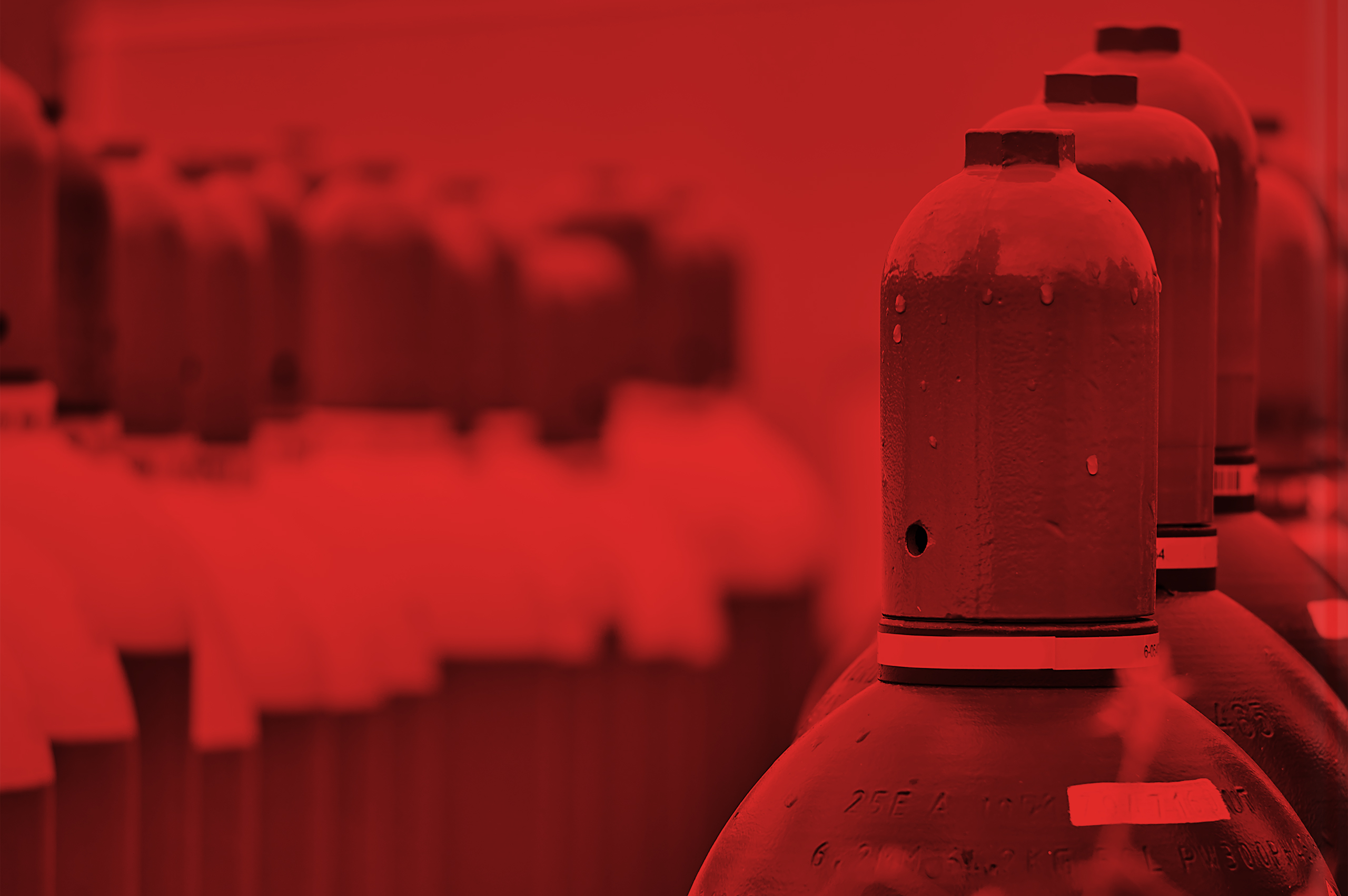 Large canisters of compressed gas in a warehouse.