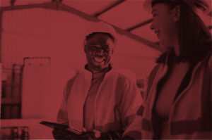 Personnel in safety gear talking in a wastewater treatment facility.